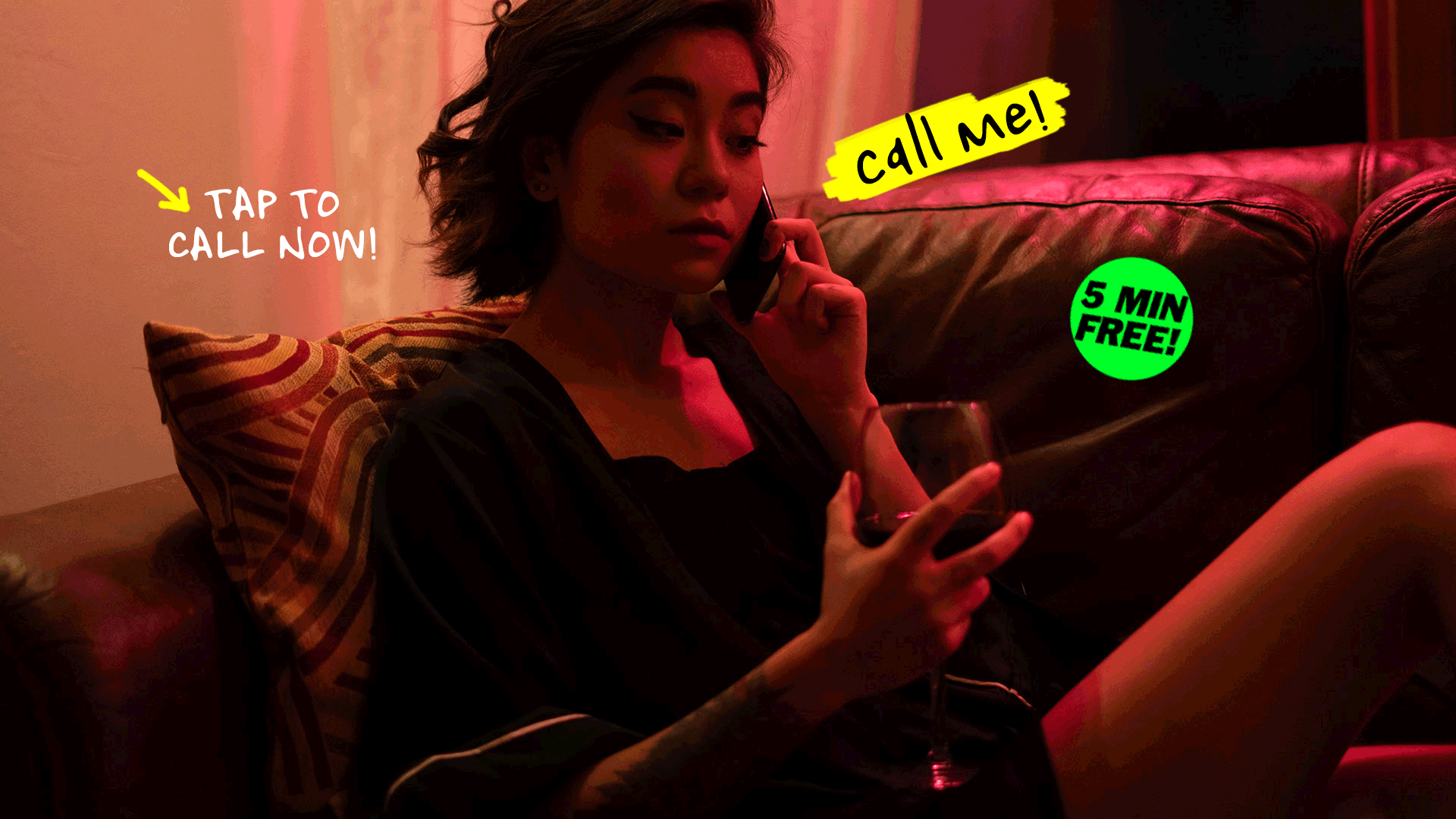 Asian girl having glass of wine talking on phone